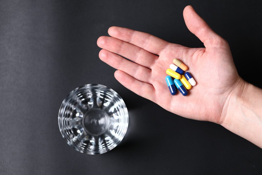 Medication and water representing tirzepatide support for medical weight loss